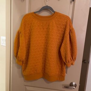 3/4 sleeve orange sweatshirt, but more stylish than a sweatshirt